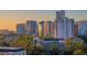 Cityscape view of high-rise buildings, lush trees, and rooftop architecture during golden hour at 401 S Palm Ave # 801, Sarasota, FL 34236