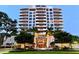 Stunning condo building featuring a symmetrical design with balconies and manicured landscaping at 401 S Palm Ave # 801, Sarasota, FL 34236