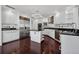 Bright kitchen with stainless steel appliances, dark countertops and hardwood floors at 401 S Palm Ave # 801, Sarasota, FL 34236