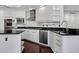 Modern kitchen featuring stainless steel appliances, granite countertops, and white cabinetry at 401 S Palm Ave # 801, Sarasota, FL 34236