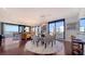 Living room featuring hardwood floors, floor to ceiling windows, and an elegant dining table at 401 S Palm Ave # 801, Sarasota, FL 34236