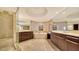 Luxurious main bathroom with dual vanities, soaking tub, walk-in shower, and elegant tile at 401 S Palm Ave # 801, Sarasota, FL 34236