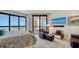 Bright main bedroom with large windows offering stunning waterfront views and balcony access at 401 S Palm Ave # 801, Sarasota, FL 34236