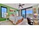 Bright bedroom with green accent wall, desk, and a balcony overlooking the city at 401 S Palm Ave # 801, Sarasota, FL 34236