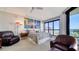 Comfortable main bedroom featuring large windows, stylish decor, and ample seating area at 401 S Palm Ave # 801, Sarasota, FL 34236