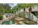 Relaxing pool and spa area with mature landscaping, comfortable loungers, and shaded seating at 401 S Palm Ave # 801, Sarasota, FL 34236