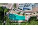 Aerial view of a community pool surrounded by lush landscaping and comfortable lounge chairs at 401 S Palm Ave # 801, Sarasota, FL 34236