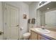 Bright bathroom featuring a vanity with sink, toilet, and framed mirror at 403 Auburn Lakes Cir # 403, Venice, FL 34292