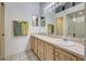 Bathroom featuring double sinks, a large mirror, vanity cabinets, and tiled flooring at 403 Auburn Lakes Cir # 403, Venice, FL 34292