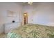 Bedroom with a dresser, ensuite bath, and ceiling fan with bright natural light at 403 Auburn Lakes Cir # 403, Venice, FL 34292
