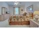 Cozy bedroom with a light color palette, complemented by carpet flooring, and a ceiling fan at 403 Auburn Lakes Cir # 403, Venice, FL 34292