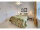 Bedroom with bright natural light, neutral carpeting, light-colored walls, and bright decor at 403 Auburn Lakes Cir # 403, Venice, FL 34292