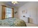 Bright bedroom with a ceiling fan, white dresser, and a window with natural light at 403 Auburn Lakes Cir # 403, Venice, FL 34292