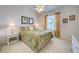 Bedroom with a large window, light-colored walls, neutral carpeting, and bright decor at 403 Auburn Lakes Cir # 403, Venice, FL 34292