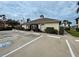 Exterior view of the community clubhouse featuring well-maintained landscaping and ample parking at 403 Auburn Lakes Cir # 403, Venice, FL 34292