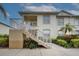 Charming two-story condo with well-maintained landscaping and inviting staircase leading to the entrance at 403 Auburn Lakes Cir # 403, Venice, FL 34292