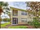 Rear exterior view of a two-story home with a screened-in balcony next to the beautiful lake at 403 Auburn Lakes Cir # 403, Venice, FL 34292