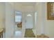 Tiled hallway with front door and a view of the office area at 403 Auburn Lakes Cir # 403, Venice, FL 34292