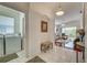 View down tiled hallway to living room and laundry room with washer and dryer at 403 Auburn Lakes Cir # 403, Venice, FL 34292