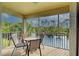 Screened lanai with seating area overlooking a serene lake, perfect for relaxing outdoors at 403 Auburn Lakes Cir # 403, Venice, FL 34292