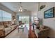 Bright living room featuring hardwood floors, ceiling fan, and sliding doors to the lanai at 403 Auburn Lakes Cir # 403, Venice, FL 34292