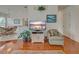 Inviting living room showcasing wood floors, natural light, and a view to the dining area at 403 Auburn Lakes Cir # 403, Venice, FL 34292