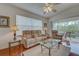 Comfortable living room featuring neutral decor, hardwood floors, and a view of the outdoor lanai at 403 Auburn Lakes Cir # 403, Venice, FL 34292