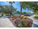 Beautiful Centennial Park entrance with vibrant flowerbeds, mature trees, and convenient parking at 445 W Gate Dr, Venice, FL 34285