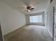 Bright bedroom with neutral carpet, ceiling fan, and ample closet space at 4506 Runabout Way, Bradenton, FL 34203