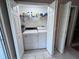 Convenient laundry closet featuring a washer, dryer, shelving, and bi-fold doors at 4506 Runabout Way, Bradenton, FL 34203