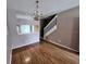 Spacious living room with wood floors, staircase access, and traditional chandelier at 4506 Runabout Way, Bradenton, FL 34203