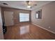 Inviting living room with beautiful wood floors, ceiling fan, and natural light from window at 4506 Runabout Way, Bradenton, FL 34203