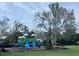 Community playground with slides, climbing structures, and seating for Gathering fun at 4506 Runabout Way, Bradenton, FL 34203