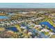 Community aerial view shows streetscape, mature trees, lakes, and nearby commercial and community properties at 4623 Claremont Park Dr, Lakewood Ranch, FL 34211