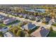 Community aerial view shows streetscape, mature trees, and homes surrounding a serene lake at 4623 Claremont Park Dr, Lakewood Ranch, FL 34211