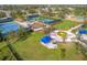 Aerial view of community amenities including tennis courts, playground, walking paths, and covered picnic areas at 4623 Claremont Park Dr, Lakewood Ranch, FL 34211
