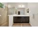Bathroom with double vanity, large mirror, and a glass-enclosed shower at 4623 Claremont Park Dr, Lakewood Ranch, FL 34211