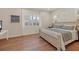 Bedroom featuring a king-size bed with white frame and light hardwood floors at 4623 Claremont Park Dr, Lakewood Ranch, FL 34211