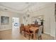 Dining area featuring a wood table, stylish chandelier, and a view of the open-concept living space at 4623 Claremont Park Dr, Lakewood Ranch, FL 34211