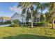 A well-kept front lawn and mature landscaping create great curb appeal for this charming one-story house at 4623 Claremont Park Dr, Lakewood Ranch, FL 34211