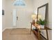 Bright and airy foyer with a large arched window above the door and a lovely wooden console table at 4623 Claremont Park Dr, Lakewood Ranch, FL 34211