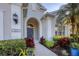 Charming home entrance with stone archway, well-maintained shrubs, and a manicured lawn at 4623 Claremont Park Dr, Lakewood Ranch, FL 34211
