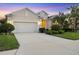 Charming single-story home with a well-manicured lawn, lush landscaping, and an attached two-car garage at 4623 Claremont Park Dr, Lakewood Ranch, FL 34211