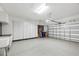 Spacious two-car garage with epoxy flooring, built-in cabinets, and ample storage space at 4623 Claremont Park Dr, Lakewood Ranch, FL 34211