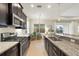 Contemporary kitchen with granite countertops, stainless steel appliances, and bright natural light at 4623 Claremont Park Dr, Lakewood Ranch, FL 34211