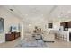 Spacious living room featuring tile floors, neutral decor, and an open layout to dining and kitchen at 4623 Claremont Park Dr, Lakewood Ranch, FL 34211