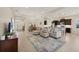 Bright living room with open layout, tile flooring, and large sectional sofa for comfortable living at 4623 Claremont Park Dr, Lakewood Ranch, FL 34211