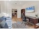 Bright office space with hardwood floors, large desk, and a view into the dining room at 4623 Claremont Park Dr, Lakewood Ranch, FL 34211