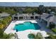 Community pool featuring multiple seating areas, a jacuzzi, and lush tropical landscaping at 4623 Claremont Park Dr, Lakewood Ranch, FL 34211