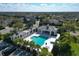 Community pool featuring a jacuzzi, covered seating areas, palm trees, and parking at 4623 Claremont Park Dr, Lakewood Ranch, FL 34211